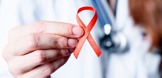 Physician with red HIV ribbon. 