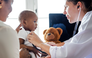 A doctor with a baby and mother. 