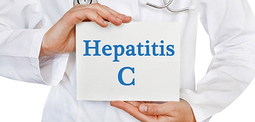 Person in lab coat holding a sign that says Hepatitis C