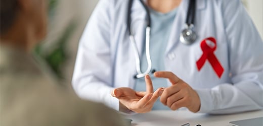 Doctor with patient wearing an HIV ribbon. 