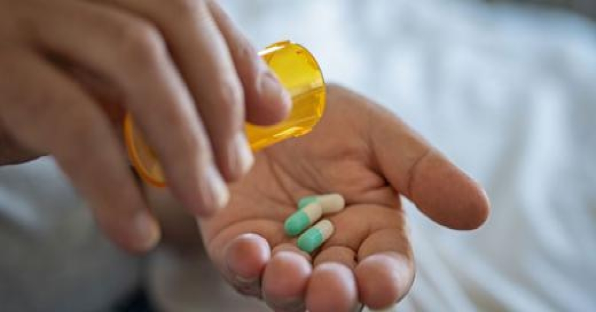 Pills in hand.