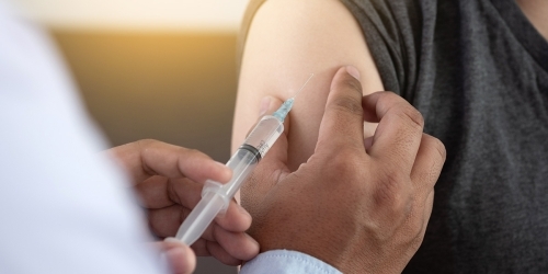 Patient receiving immunization in arm