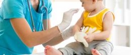 A health care professional with an infant boy.