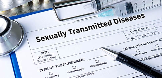 Sexually Transmitted Disease testing clipboard with needle and stethoscope.