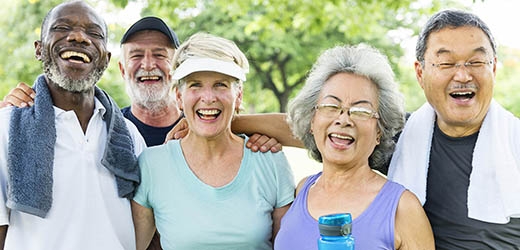 A diverse group of aging adults smiling.